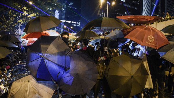Protesters protect themselves after the group occupied a main road near the central government offices in the Admiralty area in Hong Kong on September 28, 2019, on the fifth anniversary of the "Umbrella Movement". (AFP/ File Photo)