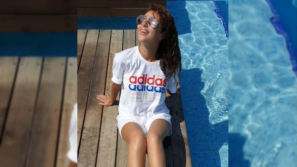Myriam Fares posted a picture of herself sitting near the pool Source myriamfares Instagram