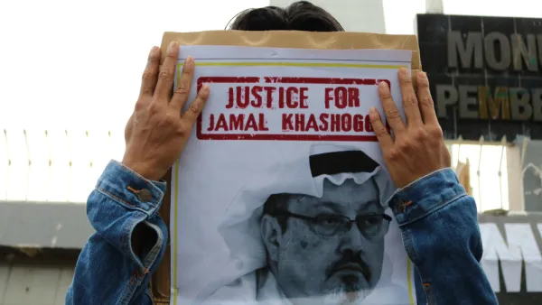 Humanitarian activists hold a poster with a picture of Jamal Khashoggi  (Shutterstock)	