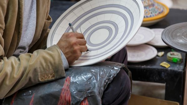 Artisan is painting dish, Berber style in ceramic factory, Fex Medina, Morocco. (Shutterstock/ File Photo)