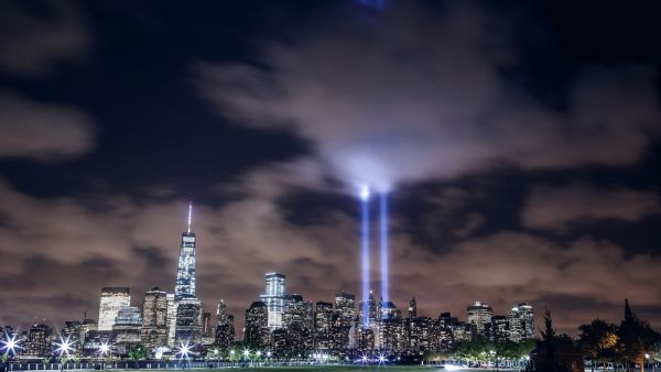 Illuminated Manhattan skyline with two beams of light in memory of 9/11 (Shutterstock)	