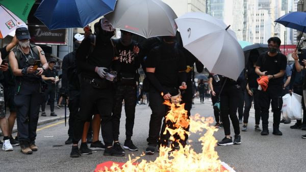 Protesters burn a Chinese national flag during a march through the streets of Hong Kong on October 1, 2019, as the city observes the National Day holiday to mark the 70th anniversary of communist China's founding. (AFP/ File Photo)