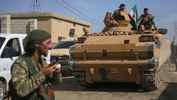 Turkish-baked Syrian fighters drive an armoured personnel carrier near the Syrian border town of Tal Abyad on October 12, 2019, as they prepare to take part in the Turkish-led assault on northeastern Syria. Bakr ALKASEM / AFP Turkish-baked Syrian fighters drive an armoured personnel carrier near the Syrian border town of Tal Abyad on October 12, 2019, as they prepare to take part in the Turkish-led assault on northeastern Syria. Bakr ALKASEM / AFP