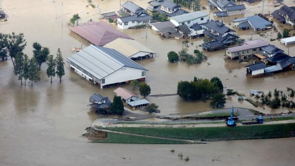 This aerial view shows flooded homes beside the collapsed bank of the Chikuma river in Nagano, Nagano prefecture on October 13, 2019, one day after Typhoon Hagibis swept through central and eastern Japan. (AFP/ File Photo)