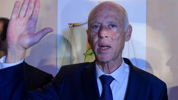 Conservative academic Kais Saied celebrates his victory in the Tunisian presidential election in the capital Tunis on October 13, 2019. Saied won a landslide victory in Tunisia's presidential runoff, sweeping aside his rival, media magnate Nabil Karoui, state television Wataniya said. It said he scooped almost 77 percent of the vote, compared to 23 percent for Karoui. Fethi Belaid / AFP
