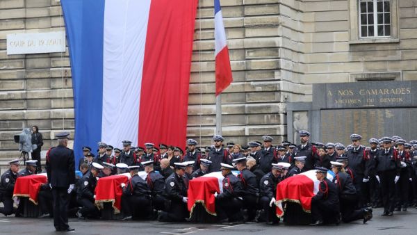 In this file photo taken on October 8, 2019 Police officers hold the coffins of their fallen colleagues during a ceremony at The Prefecture de Police de Paris (Paris Police Headquarters) in Paris, held to pay respects to the victims of an attack at the prefecture on October 4, 2019.  (AFP/ File Photo)