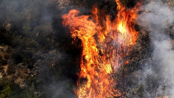 Fire takes out forests in the mountainous area that flank Damour river near the village of Meshref in Lebanon's Shouf mountains, southeast of the capital Beirut, on October 15, 2019. Flames devoured large swaths of land in several Lebanese and Syrian regions. The outbreak coincided with high temperatures and strong winds, according to the official media in both countries. JOSEPH EID / AFP