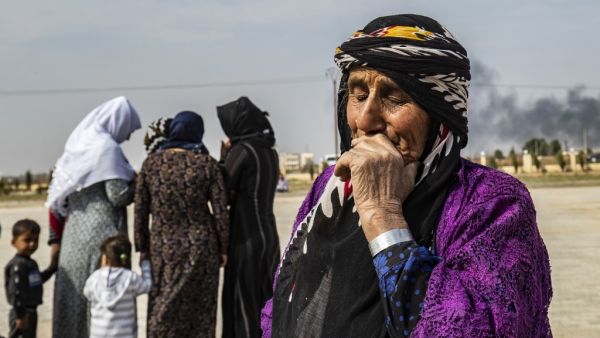 Mourners attend the funeral of civilians and fighters, who died during attacks by Turkish-led forces on the border town of Ras al-Ain, in a cemetary in Tal Tamr, near the Syrian Kurdish town of Ras al-Ain (AFP)