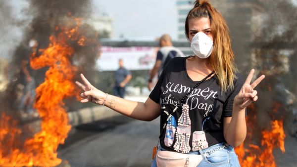 Lebanese demonstrators burn tires during a protest against dire economic conditions in the industrial zone of Dora on the northern outskirts of Beirut (AFP)