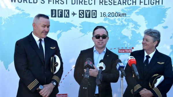 Qantas Group CEO, Alan Joyce (C) Qantas pilot, Captain Sean Golding (L) and Qantas Fleet Manager, Lisa Norman (R) speak to the media after completing a non-stop test flight from New York to Sydney at Sydney international airport on October 20, 2019. The Qantas Boeing 757 completed the flight, non-stop New York to Sydney in 19 hours and 15 minutes. (PETER PARKS / AFP)