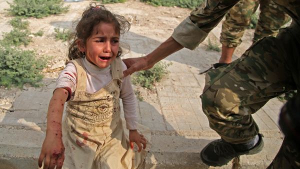A Syrian girl reacts to her wounds (AFP)