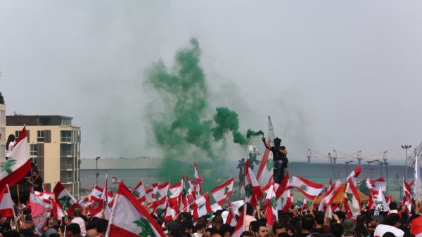 Lebanese protesters wave national flags during a rally in downtown Beirut on October 20, 2019, on the fourth day of demonstrations against tax increases and official corruption. (AFP/ File Photo)