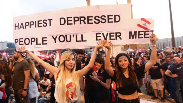 Lebanese demonstrators carry a placard as they take part in a rally in the capital Beirut's downtown district on October 20, 2019. (AFP/ File Photo)