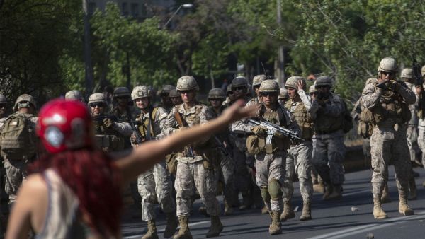 Fresh clashes broke out in Chile's capital Santiago on Sunday after two people died when a supermarket was torched overnight as violent protests sparked by anger over economic conditions and social inequality raged into a third day. (CLAUDIO REYES / AFP)