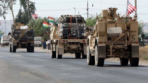 A convoy of US military vehicles arrives near the Iraqi Kurdish town of Bardarash in the Dohuk governorate after withdrawing from northern Syria on October 21, 2019. SAFIN HAMED / AFP