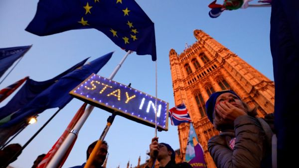 Banners, Union and EU flags are displayed outside the Houses of Parliament in London on October 22, 2019, as MPs debate the second reading of the Government's European Union (Withdrawal Agreement) Bill. (AFP/ File Photo)