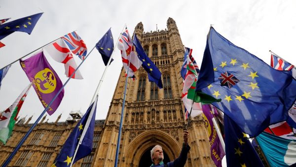 EU and Union flags belonging to Brexit activists fly outside the Houses of Parliament in London on October 23, 2019. (Tolga Akmen / AFP)