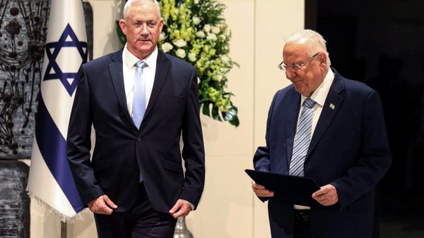 Retired Israeli general Benny Gantz (L) walks alongside President Reuven Rivlin (R) after being tasked with forming a new government, at the presidential compound in Jerusalem (AFP)