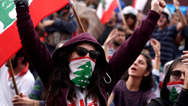 Lebanese protesters chant anti-government slogans during a broadcast by their president, in the town of Jal al Dib, northeast of Beirut, on October 24, 2019 as demonstrations to demand better living conditions and the ouster of a cast of politicians who have monopolised power and influence for decades continue. Lebanon's President Michel Aoun broke his silence after a week of unprecedented protests and expressed willingness to meet the demonstrators. "I am ready to meet your representatives... to hear your 
