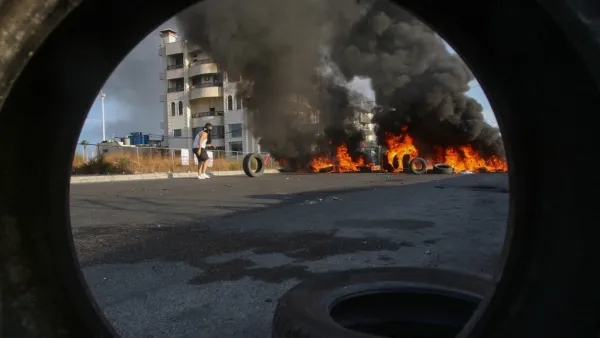Lebanese protesters block a road with burning tires during ongoing anti-government demonstrations in the southern coastal city of Saida (Sidon) on October 28, 2019. Lebanese demonstrators set up barricades and parked cars across key roads today to protest corruption and press their demands for a radical overhaul of their country's sectarian political system. Defying pleas from Lebanon's top leaders, protesters sought to keep the country on lockdown by cutting off some of the main thoroughfares, including th