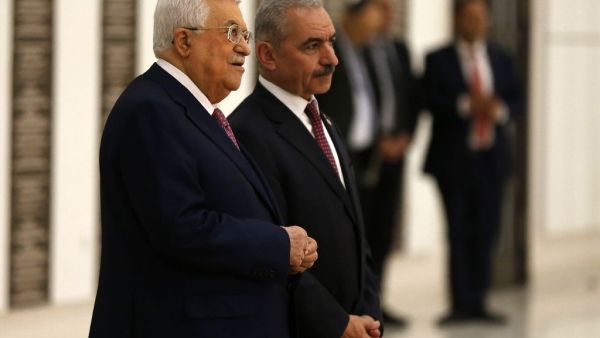 Analysts say Palestinian president Mahmud Abbas (L) retains the real decision making power despite prime minister Mohammad Shtayyeh (R) forming a new government (AFP Photo/ABBAS MOMANI)