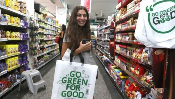 A woman poses for a photo with a reusable bag at Fahed supermarket in Beirut, Oct. 1, 2019. (The Daily Star/Mohamad Azakir)