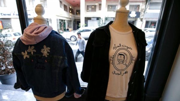 Palestinian feminist fashion items are on display at a shop in Ramallah in the occupied West Bank. The slogan reads in Arabic "a woman's voice shakes mountains". (AFP)