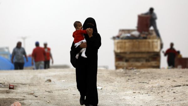 Displaced Syrians who fled the Islamic State's capital of Raqqa before it fell to Syrian forces are housed in Ain Issa, a camp north of the city. (Delil Souleiman/AFP via Getty Images)