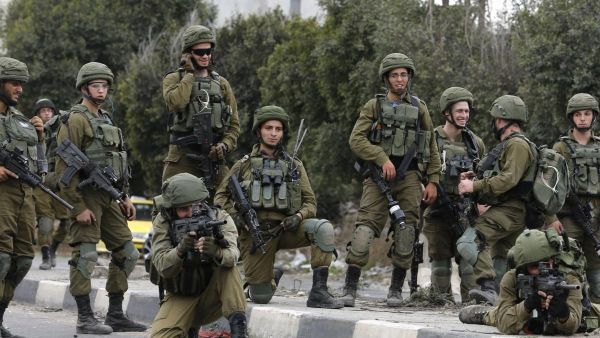 Israeli security forces are seen in the West Bank on 22 December 2017 [JAAFAR ASHTIYEH/AFP/Getty Images]