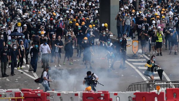 Protesters react after police fired tear gas during a rally on June 12. (AFP/ File Photo)