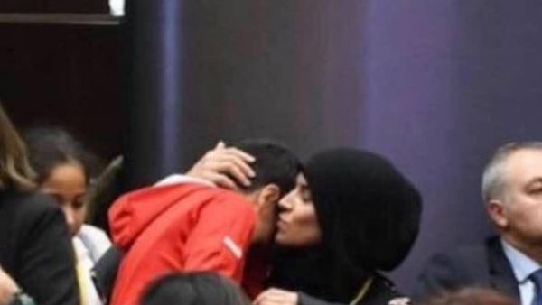 Woman at the general assembly comforting her son after having been asked to leave (Twitter)