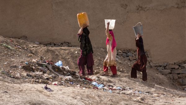 Women carrying water in Kabul, Afghanistan . (Shutterstock/ File Photo)