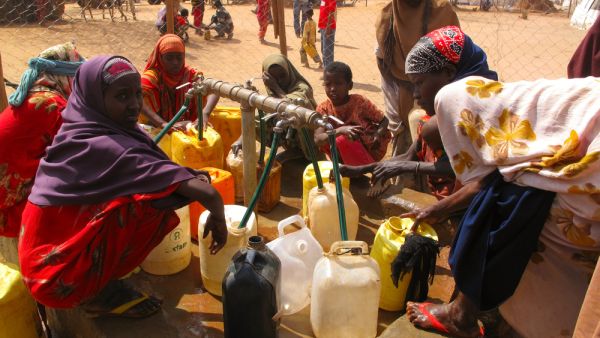 men, women & children wait for relief aid in the Dadaab refugee camp where thousands of Somalis end up due to hunger. (Shutterstock/ File Photo)