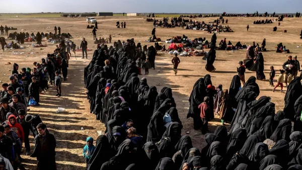 Civilians evacuated from ISIS's embattled holdout of Baghouz wait at a screening area held by the US-backed Kurdish-led Syrian Democratic Forces (SDF). (AFP/ File Photo)