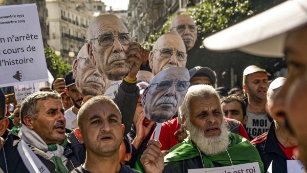 Demonstrators converged on Algiers in their thousands for a massive anti-government rally called to coincide with official celebrations of the anniversary of the war that won Algeria's independence from France. RYAD KRAMDI / AFP