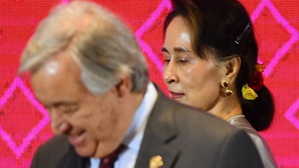 Myanmar's State Counsellor Aung San Suu Kyi (R) walks past UN Secretary-General Antonio Guterres during the 10th ASEAN-UN Summit in Bangkok on November 3, 2019, on the sidelines of the 35th Association of Southeast Asian Nations (ASEAN) Summit. Manan VATSYAYANA / AFP