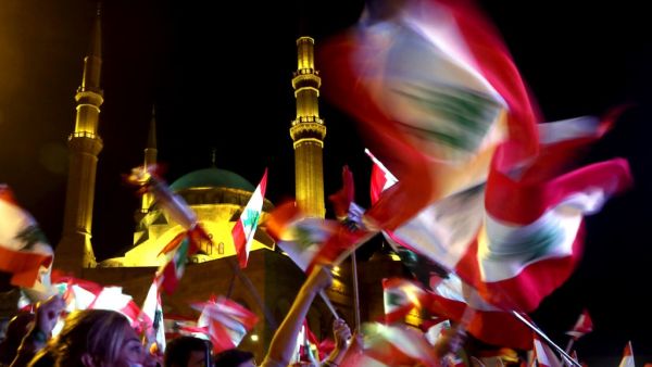 Lebanese protesters wave the national flag during an anti-government demonstration in downtown Beirut, on November 3, 2019. Unprecedented cross-sectarian demonstrations have gripped Lebanon since October 17, demanding a complete overhaul of a political system deemed inefficient and corrupt. Patrick BAZ / AFP