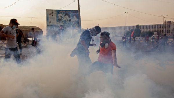 Iraqi protesters wear masks to protect themselves from tear gas as they take part in an anti-goverment demonstration in the southern city of Basra on November 8, 2019. Anti-government protests in Iraq entered their third week today amid fresh bloodshed. (AFP/ File Photo)