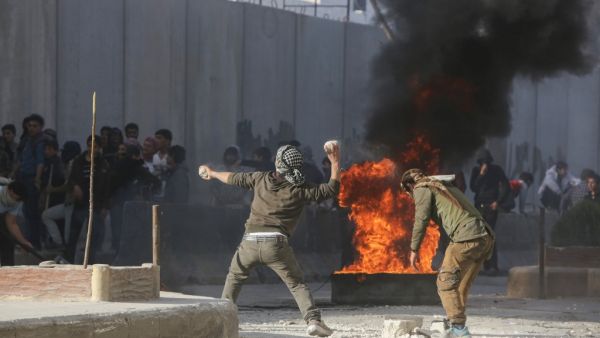 Syrian protesters hurl stones amid clashes with Turkish forces following a demonstration against Turkey's presence in northern Syria on November 17, 2019 in the town of al-Bab in Syria's northern Aleppo governorate. Turkey and its Syrian proxies control several pockets of territory on the Syrian side of the border as a result of successive incursions in 2016-17, 2018 and 2019. Bakr ALKASEM / AFP