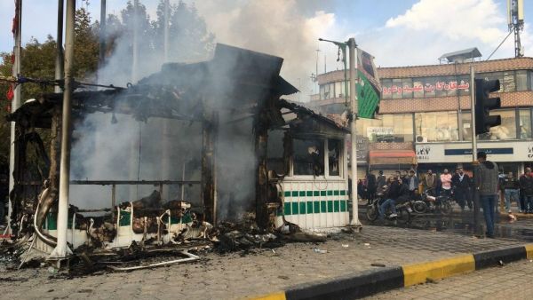 Iranians gather around a charred police station that was set ablaze by protesters during a demonstration against a rise in gasoline prices in the central city of Isfahan on November 17, 2019. (AFP/ File Photo)