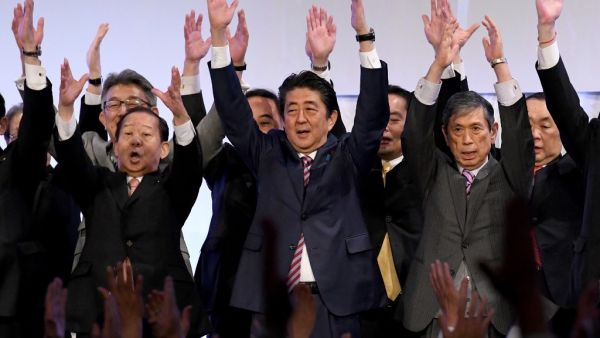 Japan's Prime Minister and ruling Liberal Democratic Party (LDP) leader Shinzo Abe (C) leads 'Banzai' shouts at the end of his party convention in Tokyo. (AFP/ File Photo)