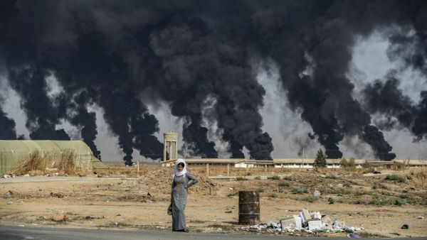 A woman stands along the side of a road on the outskirts of the town of Tal Tamr near the Syrian Kurdish town of Ras al-Ain along the border with Turkey in the northeastern Hassakeh province on October 16, 2019. (AFP/ File Photo)