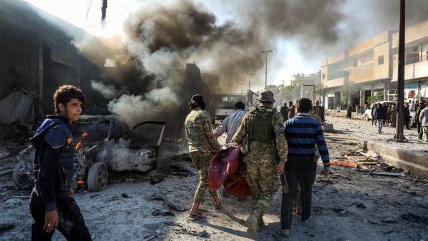 Pro-Turkish Syrian fighters carry away remains of the victims of a car bomb explosion at the industrial zone in the northern Syrian town of Tal Abyad, on the border with Turkey on November 23, 2019.  (AFP/ File Photo)