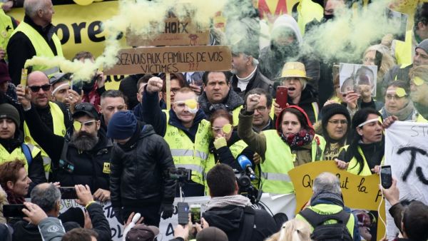 Manuel C., a "Yellow Vest" who was wounded in his left eye by a projectile likely shot by police during a "yellow vest" (gilets jaunes) demonstration on November 16, takes part alongside his wife, one of the movement's leading figures Jerome Rodrigues (3rd L) and other protesters in a march against police violence, on November 23, 2019, in the streets of Valenciennes, northern France. (AFP/ File Photo)