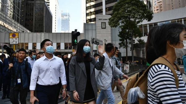 Office workers shout slogans during a lunchtime protest in the Central district in Hong Kong on November 25, 2019, a day after the city went to the polls to vote in local elections. (AFP/ File Photo)