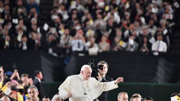 Pope Francis waves upon his arrival for a holy mass at the Tokyo Dome stadium in Tokyo on November 25, 2019. Pope Francis called on November 25 for renewed efforts to help victims of Japan's 2011 "triple disaster" of earthquake, tsunami and the Fukushima meltdown, noting "concern" in the country over the continued use of nuclear power. Vincenzo PINTO / AFP