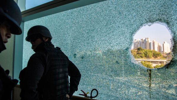 Hong Kong Police Explosive Ordnance Disposal Bureau (EOD) personnel search for explosives and chemicals at the Hong Kong Polytechnic University in the Hung Hom district of Hong Kong on November 28, 2019, over a week after police surrounded the building while pro-democracy protesters were still barricaded inside. ANTHONY WALLACE / AFP