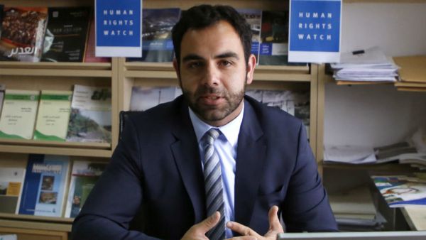 Human Rights Watch's Israel and Palestine director Omar Shakir, a US citizen, sits at his office in the West Bank city of Ramallah on May 9, 2018. (AFP/ File Photo)