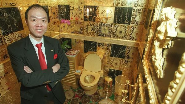 Winger Lam Sai-wing, a Hong Kong businessman, is pictured with his solid gold toilet in his office. The company chairman spent HK$38 million building the ultra-expensive washroom. (Daily Mail)