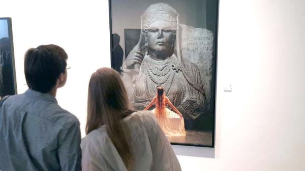 A tale of past, present and future. Visitors view a photograph by Majida Khattari. (Saad Guerraoui)
